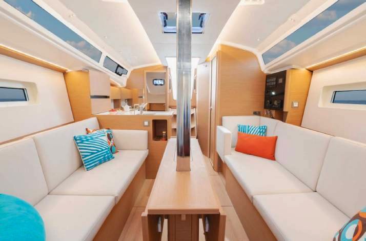  Interior of a boat featuring a cozy couch and a table, creating a comfortable space for relaxation and dining.