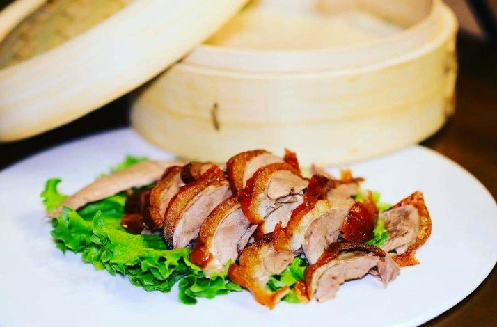 A meal of fresh duck served on a white plate at Phoenix Restaurant.
