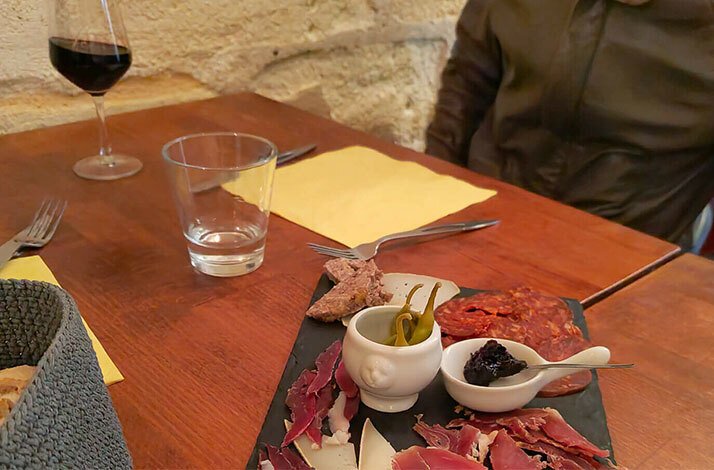 Explore Bordeaux's culinary scene on foot and take home a gourmet box: In Bordeaux, France Charcuterie board served on a food and culture walking tour of Bordeaux