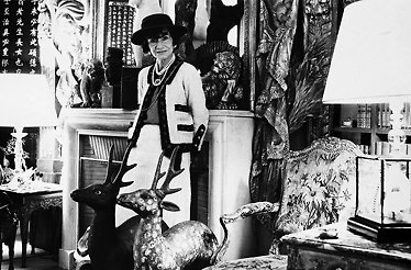 Black and white photo of Coco Chanel in a luxurious interior