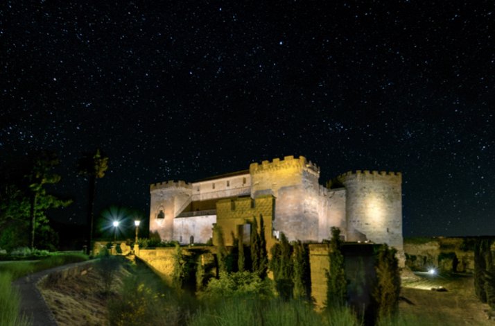 Castillo del Buen Amor illuminated at night beneath a star-filled sky in Salamanca, Spain.