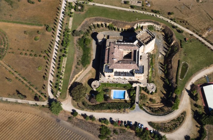 Aerial view of Castillo del Buen Amor fortress and grounds, surrounded by countryside in Salamanca.