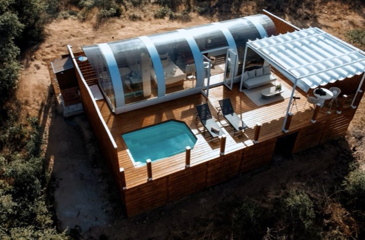 Soak up natural luxury on a sustainability-focused getaway in Córdoba: In Córdoba, Spain  Aerial view of La Dehesa Experiences, displaying a cabin with pool and lounge chairs