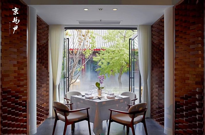 A table for four people at King's Joy vegetarian restaurant in Beijing overlooking restaurant terrace.