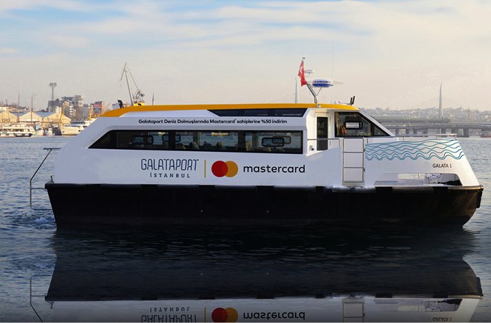 A white Galataport İstanbul Sea Shuttle ferry on the water with Mastercard branding.