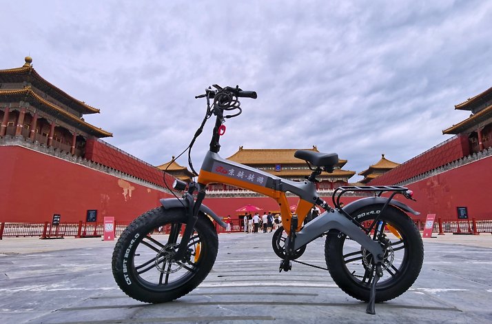 Power assisted cycle parked in front of the Forbidden City in Beijing.