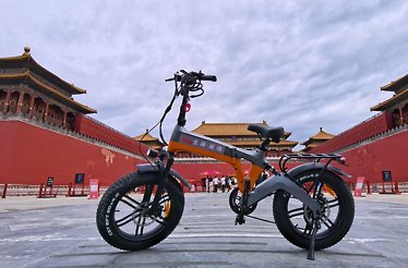 Power assisted cycle parked in front of the Forbidden City in Beijing.