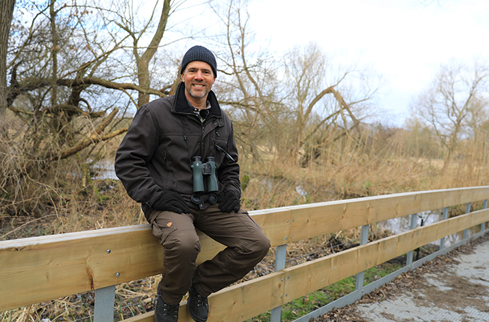Wildlife expert Derk Ehlert poses on a fence.