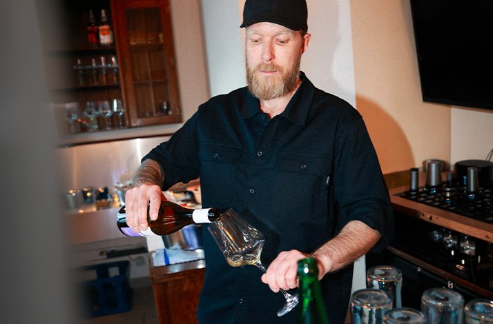 Thomas Kos, pouring a drink in his wine bar and Wiener beisl, Sagma, located in the Moabit district of Berlin.