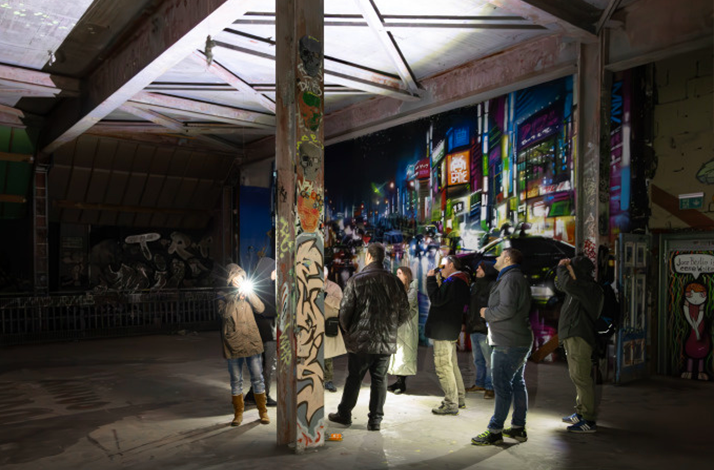 Participants discovering abandoned areas of Teufelsberg at night.