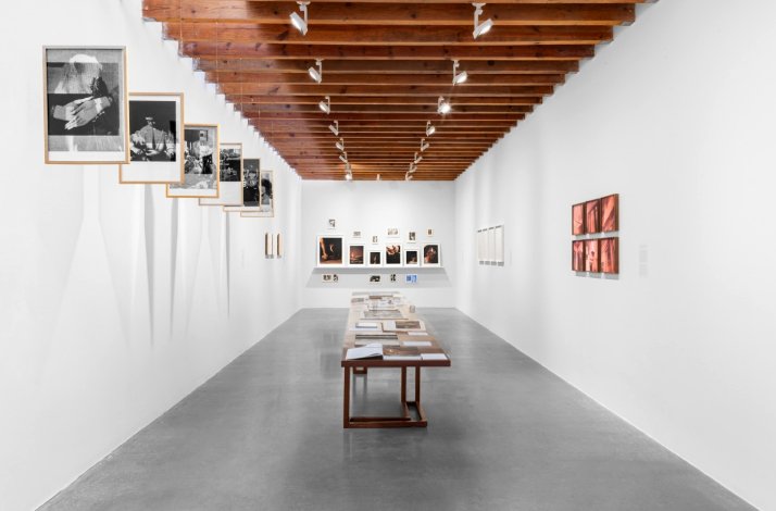 Photographs displayed on the walls and laid out on a table at the Kurimanzutto Gallery