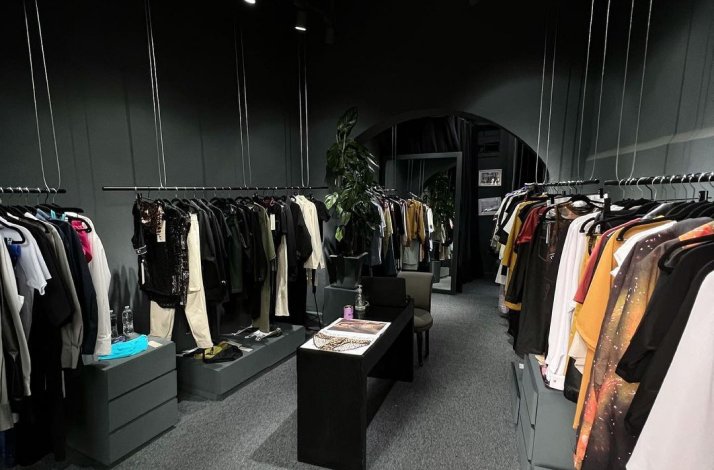 Clothing racks filled with various garments inside the Ocelote fashion house.