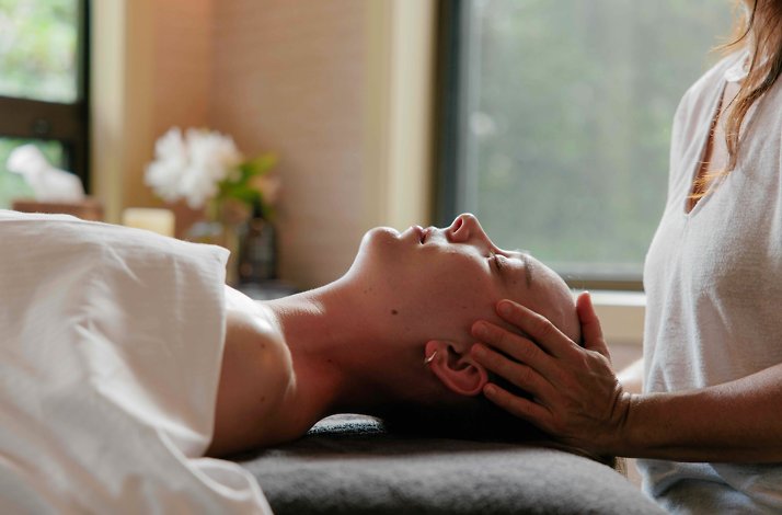 Relaxing massage session in a serene, softly lit spa room.
