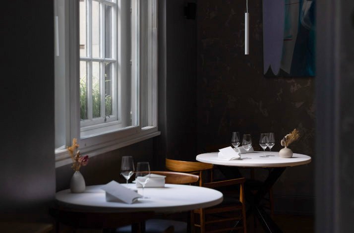 Two tables located near the window in Da Terra restaurant.