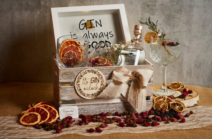 Bijeli Gusak giftbox containing a bottle of gin, 2 glasses, a souvenir photo frame, all decorated with dried citrus slices.