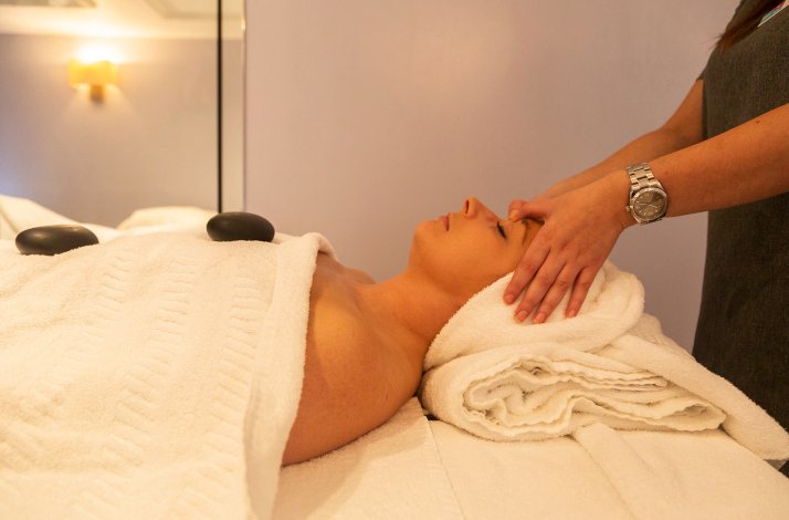 A  masseur is performing the facial massage on the lady at the Rena Spas