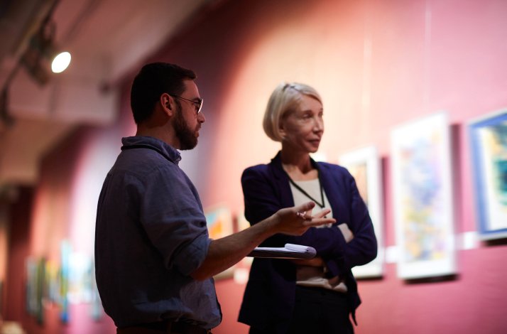 A man and a women talking in the art gallery