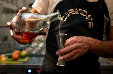 Hands of a host, whipping up tasty cocktails with viche, a cherished drink originating in Colombia's Black communities