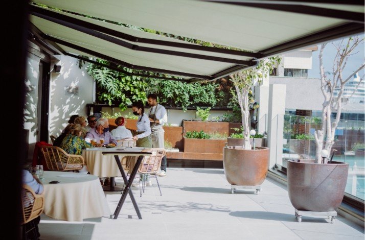 Visitors enjoying the six-course dinner with chefs delivering masterclass at Muxgo restaurant with a Michelin Green Star restaurant sunny dining room.