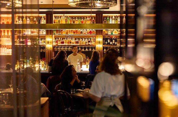 A view of the Maydanoz bar with many alcoholic drinks and bar seats