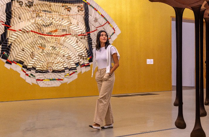 A girl walks next to an installation by Miguel Angel Rios at the Pérez Art Museum Miami.