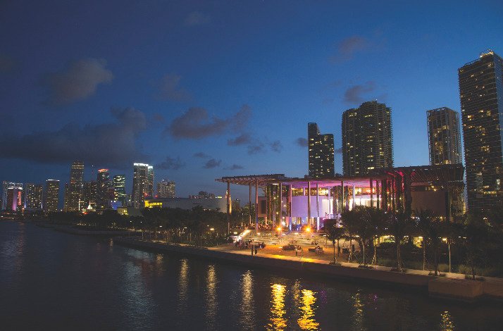 Night view of Pérez Art Museum Miami with city lights.