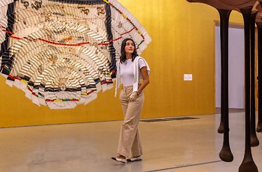 A girl walks next to an installation by Miguel Angel Rios at the Pérez Art Museum Miami.