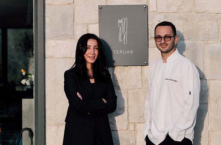 Indulge in an exclusive gourmet lunch at a Michelin-starred restaurant: In İzmir, Turkey Ezgi Serdaroğlu, Experience Curator, and Osman Serdaroğlu’s, Chef, stand in front of Teruar Urla building