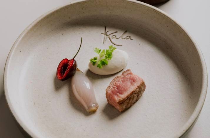 A plate featuring a serving of meat alongside a colorful assortment of vegetables prepared at the Konoba Kala.