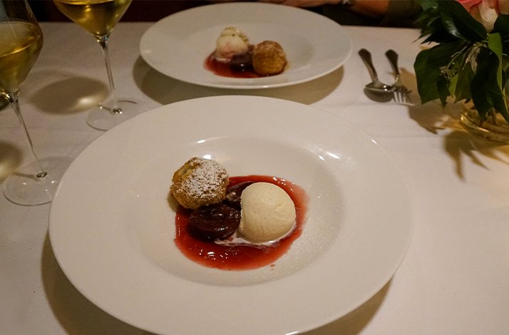 A white plate displaying a dessert at the Restaurant Nymphenburger Hof
