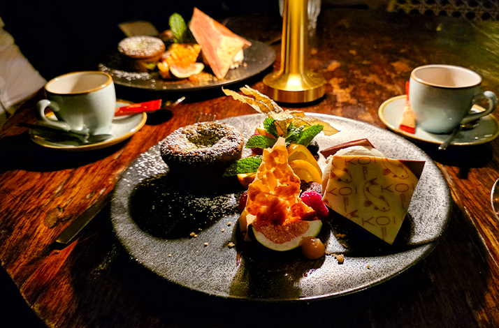 A fine-dining dish served at an elegantly decorated table in KOI Restaurant, Munich