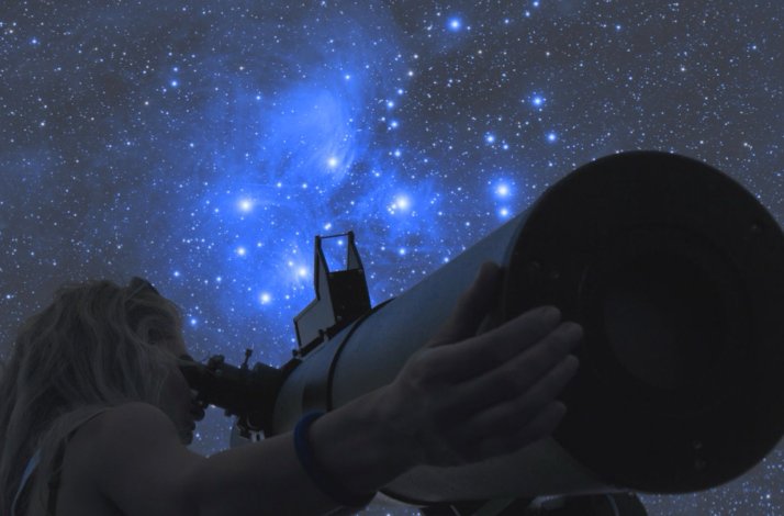 Silhouetted figure using a telescope beneath a brilliant, star-studded night sky at Cabanyes Entre Valls. Confidence: High