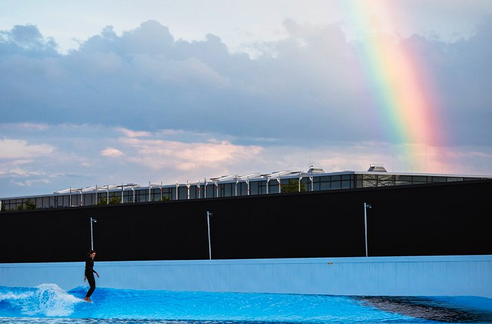 Person riding a wave during surf session at O2 Surftown in Munich, Germany.