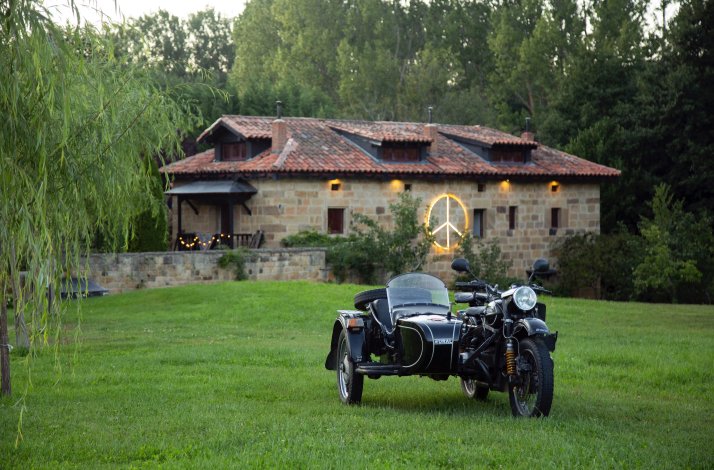 A motorcycle parked in front of a Molino Tejada hotel.