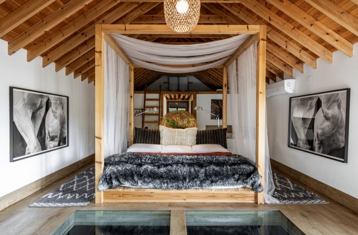 A bedroom with a canopy bed and glass floor at  Molino Tejada