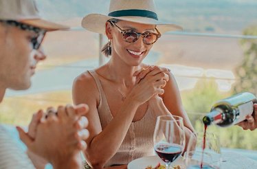 Visitors of Viña VIK watching a server pour a glass of wine