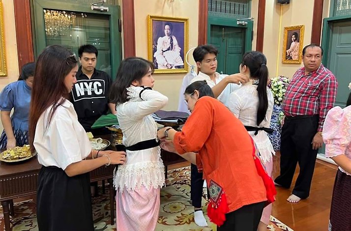 Participants trying on luxurious traditional Thai costumes for a colorful photo session