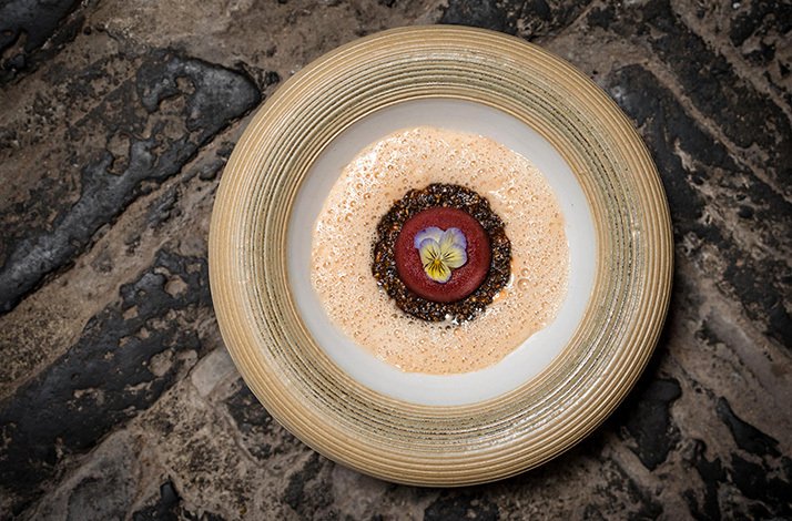 Gourmet plating from Rura Restaurant, of a type of food with spices and a flower as decoration