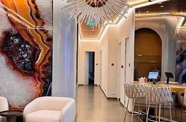 A modern workspace highlighted by a large marble wall of the SKINMED CLINIC located at the centre of Romania.