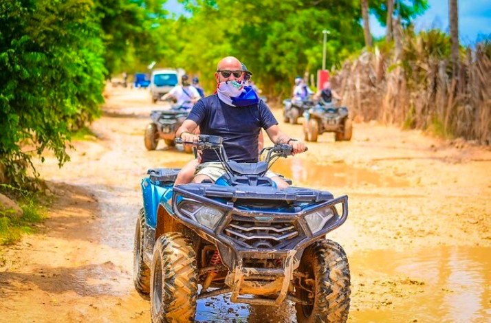 A person riding an ATV on a country road in Punta Cana