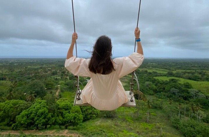 A person sitting on a swing at a viewpoint on Round Mountain
