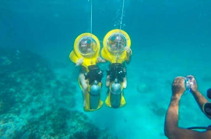 Two participants of Scuba doo diving posing for a picture under the Caribbean sea.
