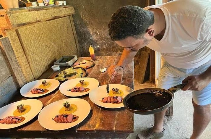 Chef Avinash Martins decorating plates of dish from seasonal farm-to-table menu.