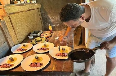 Chef Avinash Martins decorating plates of dish from seasonal farm-to-table menu.