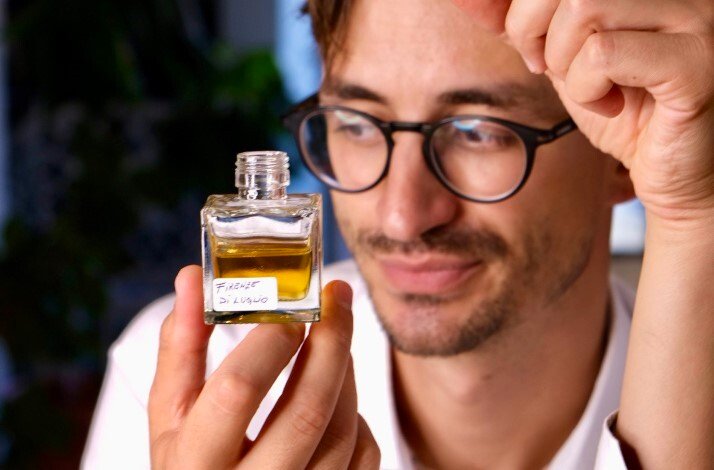A male model holding an example of unique eco-friendly perfume by Crispy