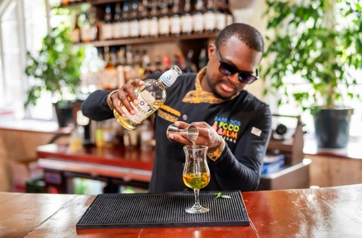 A barman pouring liqueur to a glass