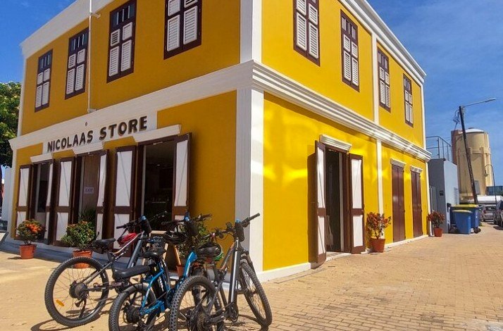 Three bicycles are parked outside the Nicolaas store at Oranjestad, Aruba.