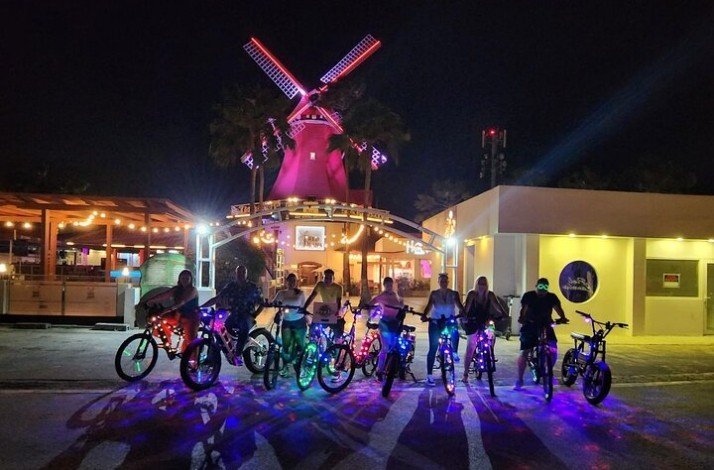 Group of tourists posing in front of the iconic Old Dutch Windmill
