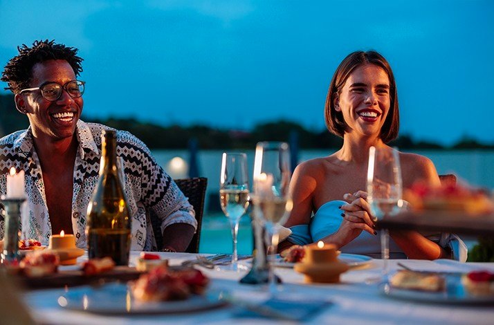 Visitors enjoying the evening at the outdoor dining area of the Sand Street Bistro.