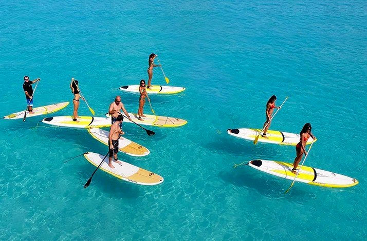 Eight participants of the activity getting ready to surf